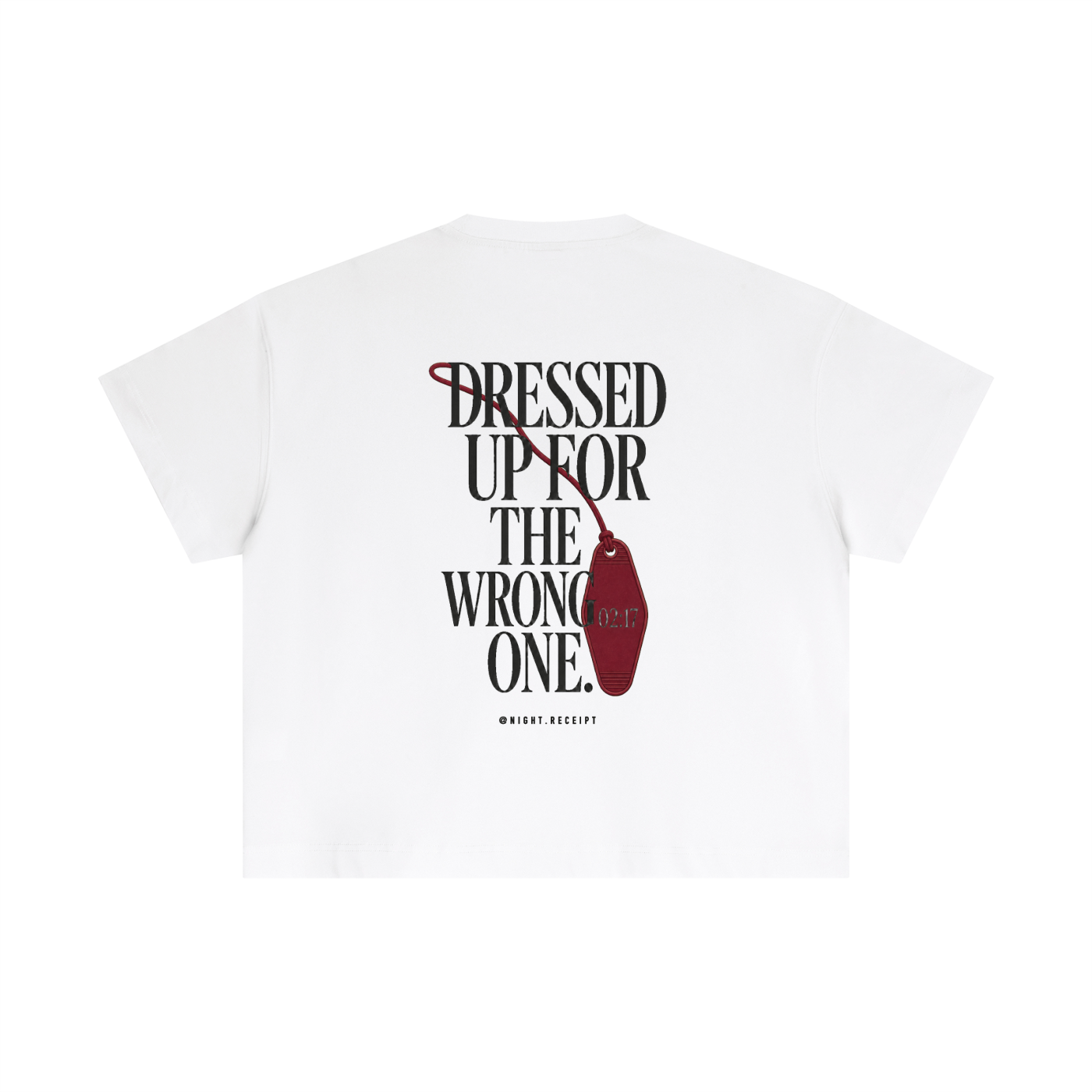 Back of the white Night Receipt boxy cotton tee with DRESSED UP FOR THE WRONG ONE in editorial serif capitals and an unbranded oxblood hotel key tag stamped 02:17 hanging off the type