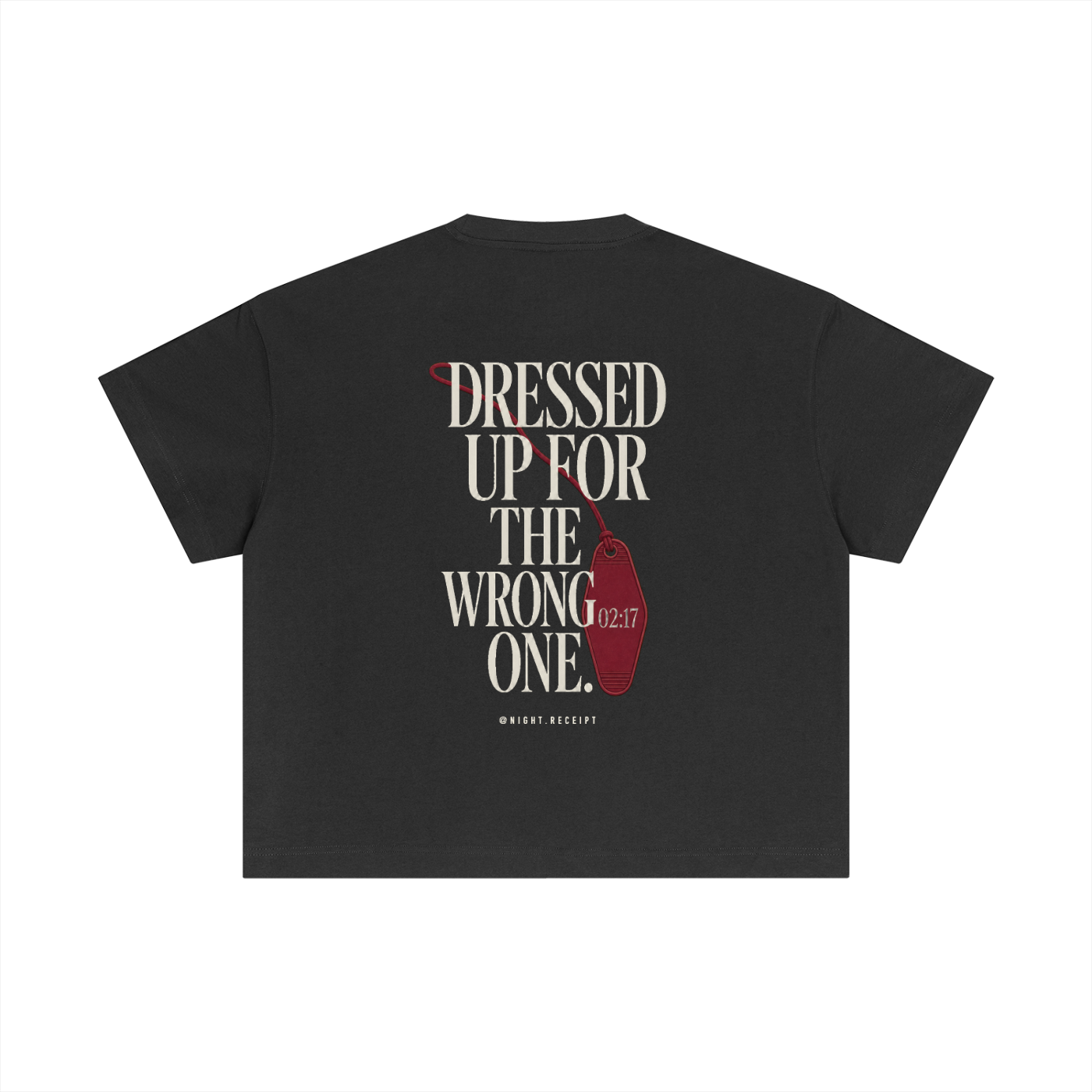 Back of the dark gray Night Receipt boxy cotton tee with DRESSED UP FOR THE WRONG ONE in editorial serif capitals and an unbranded oxblood hotel key tag stamped 02:17 hanging off the type